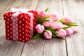 Beautiful tulips with red polka-dot gift box. Royalty Free Stock Photo