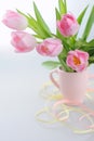 Beautiful tulips in a vase with decorative paper