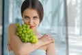 Beautiful turkish woman holding a bunch of grapes Royalty Free Stock Photo