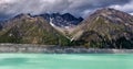 Beautiful turqouise Tasman Glacier Lake and Rocky Mountains in the clouds, Mount Cook National Park, New Zealand