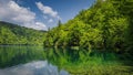 Beautiful turquoise end emerald water with trees reflected in a lake in Plitvice Lakes Royalty Free Stock Photo