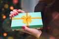 Turquoise gift box in the hands of a girl. Royalty Free Stock Photo