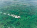 Beautiful turquoise ocean water with boat on it top view aerial photo. Royalty Free Stock Photo