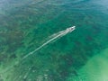 Beautiful turquoise ocean water with boat on it top view aerial photo. Royalty Free Stock Photo