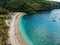 Beautiful turquoise ocean water with many boats on it top view aerial photo with white beach and jungle of tropical Royalty Free Stock Photo