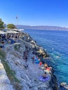 Beautiful turquoise rocky seascape with a famous swimming place full of tourists and visitors near Hydronetta coctail bar in Hydra Royalty Free Stock Photo