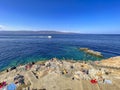 Beautiful turquoise rocky seascape with a famous swimming place full of tourists and visitors near Hydronetta coctail bar in Hydra Royalty Free Stock Photo