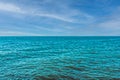 Beautiful turquoise sea water against the blue sky. View from a tropical beach. Summer sunny day, rest Royalty Free Stock Photo