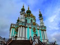 Beautiful turquoise St. Andrew`s Church in Kiev, isolated on a background of blue sky. Bottom view of the magnificent baroque