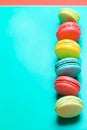 Beautiful turquoise vertical background with colorful macaroons and copy space