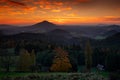 Beautiful twilight sunset landscape. Evening with hills and villages. Sun with ping and orange sky, Czech national Park Ceske Svyc