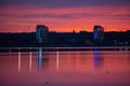 Beautiful twilight view of Kuyalnik liman with traffic and city light reflecting in calm water of firth with bright red