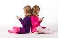 Beautiful twin girls text messaging Royalty Free Stock Photo