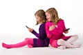 Beautiful twin girls text messaging Royalty Free Stock Photo