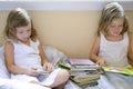 Beautiful twin little girls doing homework Royalty Free Stock Photo