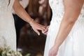 Beautiful two brides at same sex couple wedding ceremony holding hands in white dresses