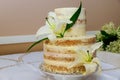 Beautiful naked cake with cream and white lily Royalty Free Stock Photo