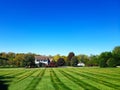 beautiful two story country home with a large manicured lawn and landscaping in the front yard. Landscape under a blue sky Royalty Free Stock Photo