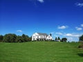 beautiful two story country home with a large manicured lawn and trees in the front yard Royalty Free Stock Photo