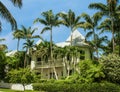 Beautiful two story white house with tall palm trees and picket fence in Key West Florida USA Royalty Free Stock Photo