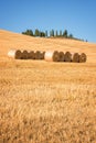 Beautiful typical landscape of Val d`Orcia in Tuscany with hay bales in a field in summer, Val d`Orcia, Tuscany Italy