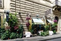 Beautiful typical Roman cafe full of flowers located in the str