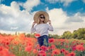 Beautiful ukrainian lady alone at flowers poppies field  sunny day Royalty Free Stock Photo