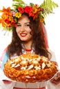 Beautiful ukrainian woman in garland and native costume holding