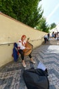 Beautiful Ukrainian woman playing a musical instrument bandura on the streets of Prague.