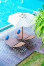 Beautiful umbrella and chair around swimming pool in hotel and r
