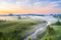 Beautiful underground fog over a small river among grassy meadows in rural areas, early in the morning at dawn Royalty Free Stock Photo