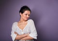 Beautiful unhappy woman in white shirt looking with disgust and grimacing the face on purple background Royalty Free Stock Photo