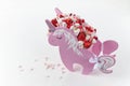 A beautiful unicorn shaped box filled with ripe strawberries and sweets