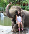 Beautiful unique elephant with girl at an elephants conservation reservation in Bali Indonesia