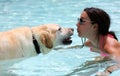 Beautiful unique golden retriever labrador dog and girl relaxing at the pool in a floating bed, dog super funny. Royalty Free Stock Photo