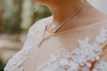 Beautiful unrecognizable bride - closeup shot. beautiful pearls on neck Bride, wedding accessories. Beautiful bride