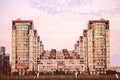 A beautiful unusual building in several rows against the background of a blue sky