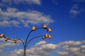 Beautiful vintage yellow lanterns glow against the blue sky in the clouds. Unusual street electric lighting, lamps. Dnepropetrovsk