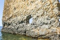 Beautiful and unusual rock with a hole. Flat and vertical. Rocky surface texture. Located near the city of Gelendzhik in the