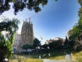 Beautiful unusual view of the famous historical building of the architect Gaudi`s Basilica de la sagrada Familia and the pond.