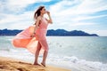 Beautiful unusual woman walking on the beach