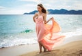 Beautiful unusual woman walking on the beach