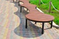 Beautiful, unusual wooden park bench. Empty park bench in the summer