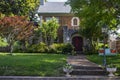 Beautiful upscale house with rock castle like entrance and retro metal lounger and little rabbit in front yard - curb appeal Royalty Free Stock Photo