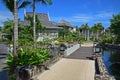 Beautiful upscale resort hotel with small wooden bridge connecting to the villas with abundant trees around Royalty Free Stock Photo