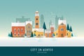 Beautiful urban landscape or cityscape with colorful antique buildings, towers and green spruce trees covered with snow
