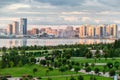 Beautiful urban landscape with a road, a Park and a lake at sunset