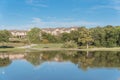 Beautiful urban park with lake reflection and apartment complex in background near Dallas