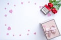 Beautiful Valentine`s Day background with red hearts, roses, gift box and proposal rings on white banner background. Royalty Free Stock Photo