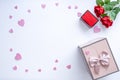 Beautiful Valentine`s Day background with red hearts, roses, gift box and proposal rings on white banner background. Royalty Free Stock Photo